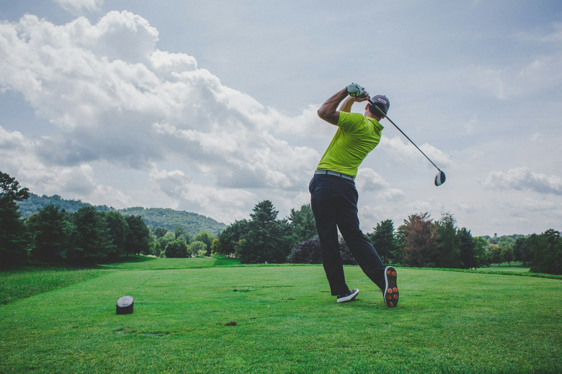 A golfer following through on a tee shot